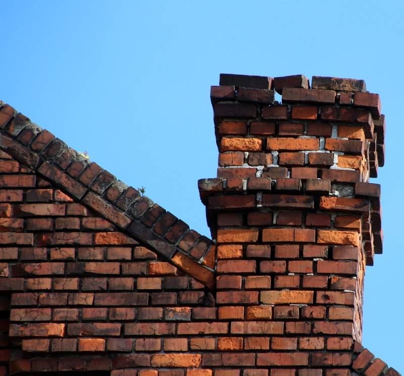 Signs Your Dracut Home Needs a Chimney Inspection Damaged chimney on an Dracut home showing cracks and missing mortar